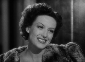 Movie still from “The Women” (1939), directed by George Cukor – An old photo of an older woman smiling for the camera; Close Up shot, High angle