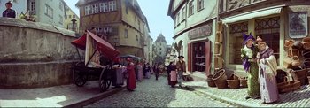 Movie still from “The Wonderful World of the Brothers Grimm” (1962), directed by Henry Levin – A group of people walking down a street; Extreme Wide shot, High angle