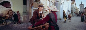 Movie still from “The Wonderful World of the Brothers Grimm” (1962), directed by Henry Levin – A man and a woman sitting on a bench; Medium shot, High angle
