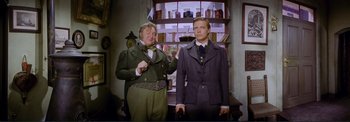 Movie still from “The Wonderful World of the Brothers Grimm” (1962), directed by Henry Levin – A man and a woman standing next to each other; Medium shot, Low angle