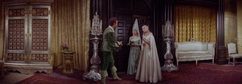 Movie still from “The Wonderful World of the Brothers Grimm” (1962), directed by Henry Levin – Two women and a man dressed in medieval costumes; Wide shot, High angle