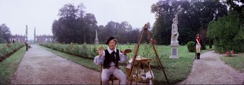 Movie still from “The Wonderful World of the Brothers Grimm” (1962), directed by Henry Levin – An old man sitting on a chair in front of an easel; Wide shot, High angle