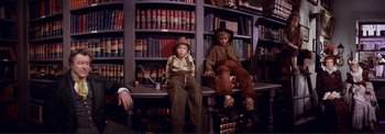 Movie still from “The Wonderful World of the Brothers Grimm” (1962), directed by Henry Levin – Two boys sitting in front of a book shelf; Medium shot, High angle