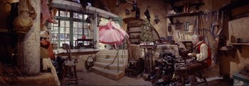 Movie still from “The Wonderful World of the Brothers Grimm” (1962), directed by Henry Levin – A woman in a pink dress standing on some stairs; Wide shot, High angle