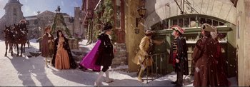 Movie still from “The Wonderful World of the Brothers Grimm” (1962), directed by Henry Levin – Two men dressed in period clothing walking down the street; Wide shot, High angle