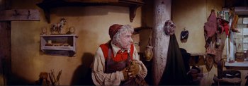 An old man dressed in a red shirt and a red hat