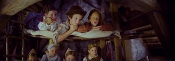 Movie still from “The Wonderful World of the Brothers Grimm” (1962), directed by Henry Levin – A group of children sitting on top of a bunk bed; Medium shot, High angle