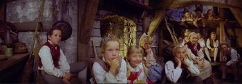 Movie still from “The Wonderful World of the Brothers Grimm” (1962), directed by Henry Levin – Three young children dressed in medieval clothing; Medium shot, High angle