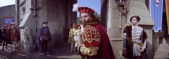 Movie still from “The Wonderful World of the Brothers Grimm” (1962), directed by Henry Levin – A group of people dressed up in costumes; Medium shot, Low angle