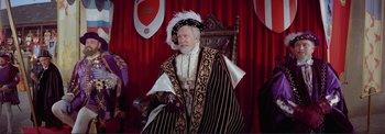 Movie still from “The Wonderful World of the Brothers Grimm” (1962), directed by Henry Levin – An old man dressed as a king sitting in a chair; Medium shot, Over the shoulder angle
