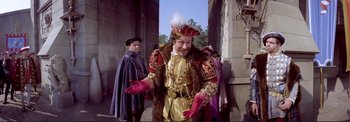 Movie still from “The Wonderful World of the Brothers Grimm” (1962), directed by Henry Levin – A man dressed as a renaissance king in a costume; Medium shot, Over the shoulder angle