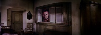 Movie still from “The Wonderful World of the Brothers Grimm” (1962), directed by Henry Levin – A picture of a man's face in a window; Medium shot, Low angle
