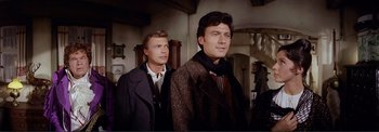 Movie still from “The Wonderful World of the Brothers Grimm” (1962), directed by Henry Levin – Two men standing next to each other in a room; Medium shot, Low angle