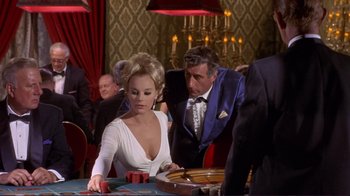 Movie still from “The Wrecking Crew” (1968), directed by Phil Karlson – A man and a woman playing a game of roulette; Medium shot, Over the shoulder angle