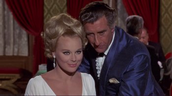 Movie still from “The Wrecking Crew” (1968), directed by Phil Karlson – A man and a woman posing for a picture; Medium shot, High angle