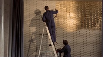 Movie still from “The Wrecking Crew” (1968), directed by Phil Karlson – Two men on a ladder painting a brick wall; Medium shot, Low angle