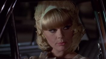 Movie still from “The Wrecking Crew” (1968), directed by Phil Karlson – A person wearing a hat; Close Up shot, Over the shoulder angle