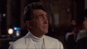 Movie still from “The Wrecking Crew” (1968), directed by Phil Karlson – A person wearing a suit and tie; Close Up shot, Over the shoulder angle