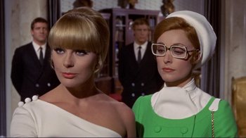 Movie still from “The Wrecking Crew” (1968), directed by Phil Karlson – A couple of women standing next to each other in a room; Close Up shot, Low angle