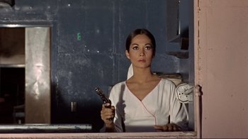 Movie still from “The Wrecking Crew” (1968), directed by Phil Karlson – A woman holding a remote control in her hand; Close Up shot, Low angle