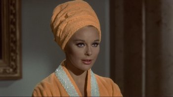 Movie still from “The Wrecking Crew” (1968), directed by Phil Karlson – A woman with a towel wrapped around her head; Close Up shot, Low angle