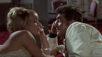 Movie still from “The Wrecking Crew” (1968), directed by Phil Karlson – A man and a woman sitting next to each other; Medium shot, Over the shoulder angle