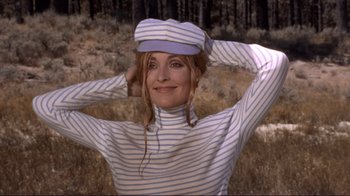 Movie still from “The Wrecking Crew” (1968), directed by Phil Karlson – A woman wearing a striped shirt and a hat; Medium shot, Low angle