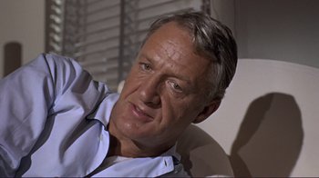Movie still from “The Wrecking Crew” (1968), directed by Phil Karlson – An older man sitting in front of a window; Close Up shot, Low angle