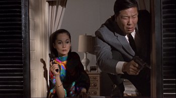 Movie still from “The Wrecking Crew” (1968), directed by Phil Karlson – A man and a woman in a living room; Medium shot, Low angle