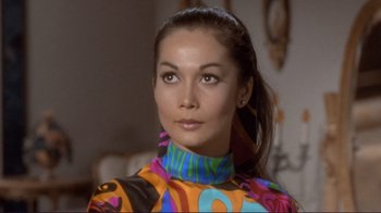 Movie still from “The Wrecking Crew” (1968), directed by Phil Karlson – A woman in a brightly colored outfit looking at the camera; Close Up shot, High angle
