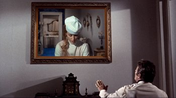 Movie still from “The Wrecking Crew” (1968), directed by Phil Karlson – A man sitting in front of a mirror in a room; Medium shot, Over the shoulder angle