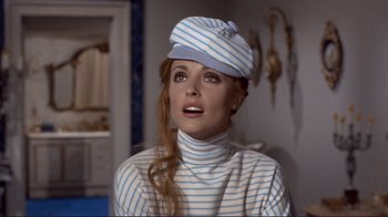 Movie still from “The Wrecking Crew” (1968), directed by Phil Karlson – A woman wearing a striped shirt and a hat; Close Up shot, Low angle