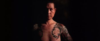 Movie still from “The Yakuza” (1974), directed by Sydney Pollack – A man with a tattoo on his chest and arms; Close Up shot, Low angle