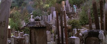 Movie still from “The Yakuza” (1974), directed by Sydney Pollack – An old cemetery with many tombstones in the background; Extreme Wide shot, Low angle