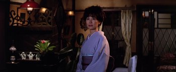 Movie still from “The Yakuza” (1974), directed by Sydney Pollack – A woman wearing a purple kimono standing in a room; Medium shot, Low angle