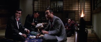 Movie still from “The Yakuza” (1974), directed by Sydney Pollack – A group of men sitting around a table; Medium shot, Low angle