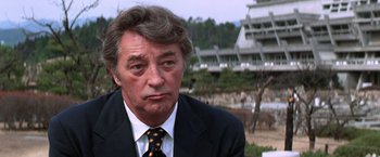 Movie still from “The Yakuza” (1974), directed by Sydney Pollack – A person wearing a suit and tie; Close Up shot, Over the shoulder angle