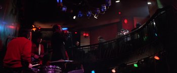 Movie still from “The Yakuza” (1974), directed by Sydney Pollack – A person standing on a stage with a microphone; Wide shot, Low angle