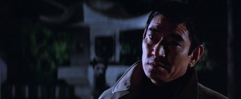 Movie still from “The Yakuza” (1974), directed by Sydney Pollack – A person wearing a jacket; Close Up shot, Low angle