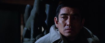 Movie still from “The Yakuza” (1974), directed by Sydney Pollack – A person wearing a jacket; Close Up shot, Low angle