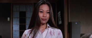 Movie still from “The Yakuza” (1974), directed by Sydney Pollack – A woman with long black hair wearing a white shirt; Close Up shot, Low angle