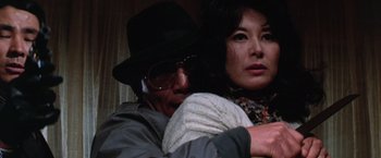 Movie still from “The Yakuza” (1974), directed by Sydney Pollack – A man and a woman embracing each other; Close Up shot, Low angle
