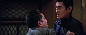 Movie still from “The Yakuza” (1974), directed by Sydney Pollack – Two men are facing each other in a room; Close Up shot, Low angle