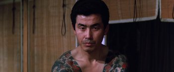 Movie still from “The Yakuza” (1974), directed by Sydney Pollack – A person with a tattoo on his chest; Close Up shot, Low angle