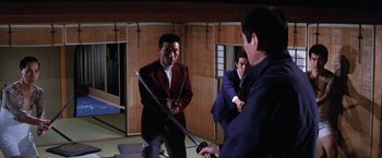 Movie still from “The Yakuza” (1974), directed by Sydney Pollack – A group of men in a room holding swords; Wide shot, Low angle
