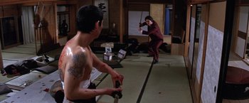 Movie still from “The Yakuza” (1974), directed by Sydney Pollack – Two men are practicing martial arts in a room; Wide shot, Low angle