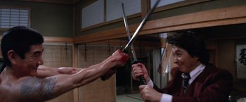 Movie still from “The Yakuza” (1974), directed by Sydney Pollack – Two people are holding swords in their hands; Medium shot, Low angle