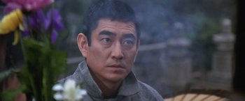 Movie still from “The Yakuza” (1974), directed by Sydney Pollack – A person wearing a jacket; Close Up shot, Over the shoulder angle