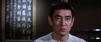 Movie still from “The Yakuza” (1974), directed by Sydney Pollack – A person wearing a sweater; Close Up shot, Low angle