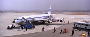 Movie still from “The Yakuza” (1974), directed by Sydney Pollack – An american airlines jet sitting on top of an airport runway; Extreme Wide shot, High angle